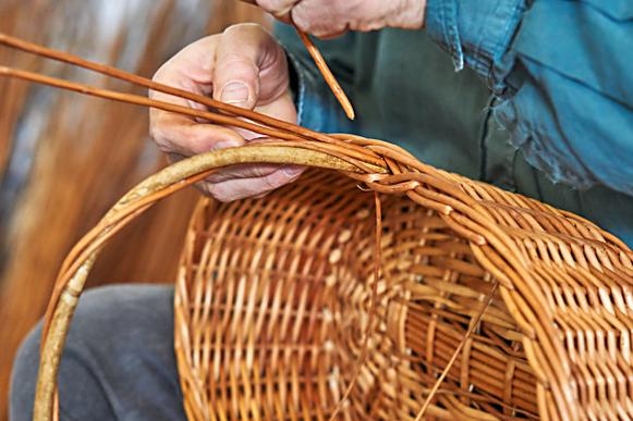 Artisan weaving natural materials by hand